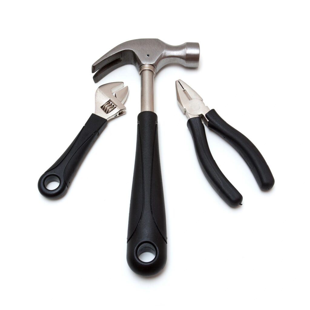 Spray gun cleaning kit items on a clean background (brushes, needles, lubricant)
